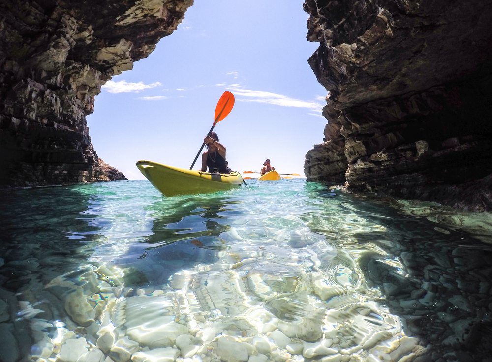 Explore the cave by kayak